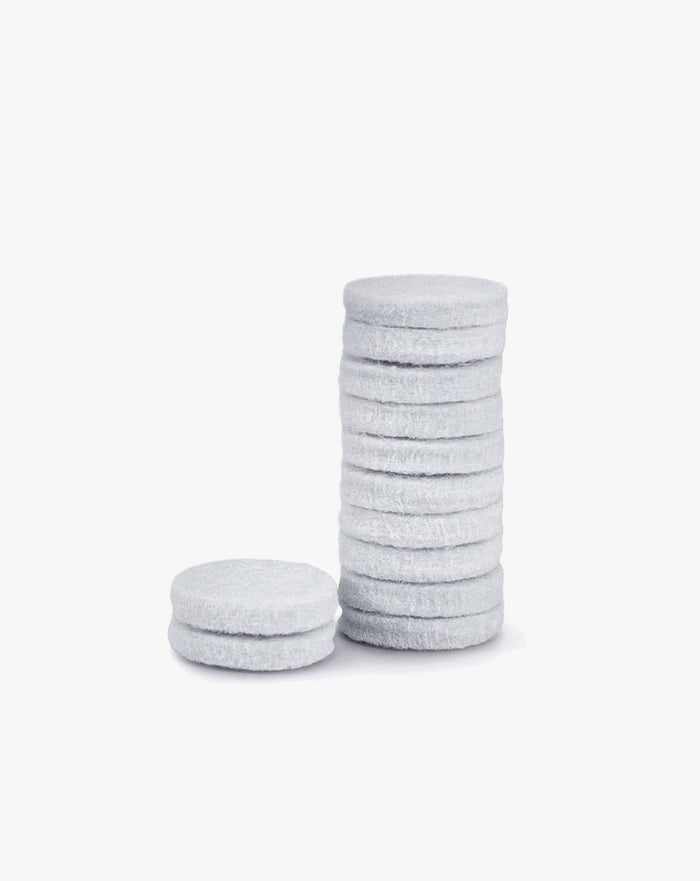 Grey air purifier aroma pads, stacked with one loose pad (12-pack replacement)
